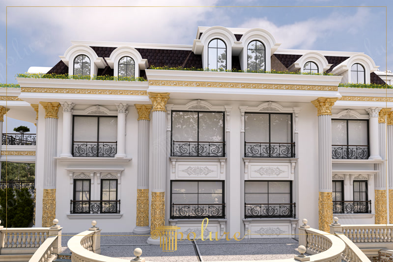 Mansard çatıda kemerli dormer pencereleri, oymalı söve panoları ve ön planda kavisli teras balustradları olan lüks villa cephesi.