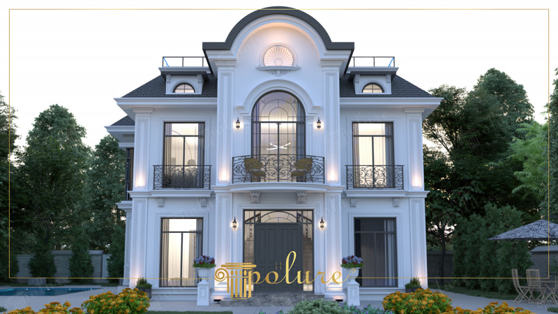 Akşam aydınlatması altında büyük merkezi kemeri, Fransız balkonları ve söve çerçeveleri olan neoklasik villa cephesi