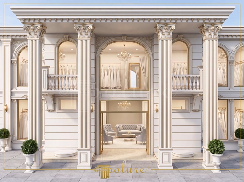 Simetrik korint sütunlar, kemerli söveler ve altın yaldızlı detaylarla süslenmiş iki katlı lüks gelinlik showroom dış cephesi.