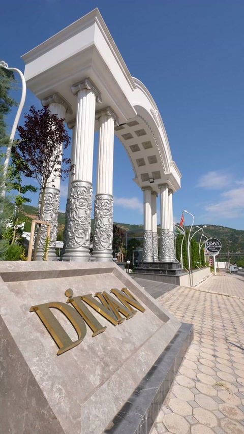Köşe girişinde sütunlar, bezemeli kaideler ve geniş kemer birleşiyor