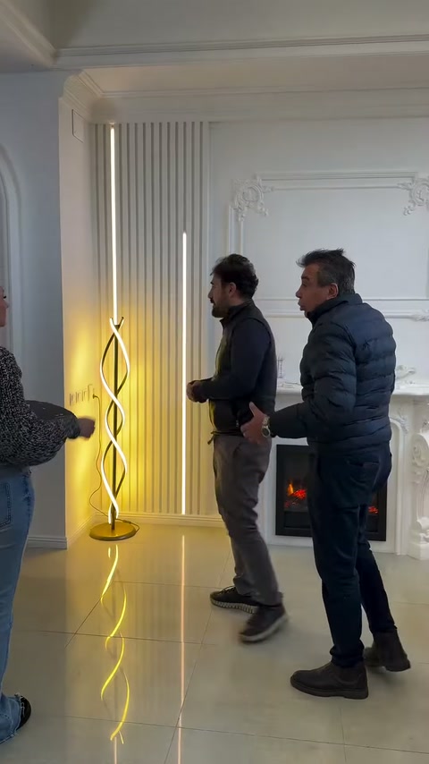 İki kişi, dikey çıtalı duvar ve şömine uygulamasını inceliyor