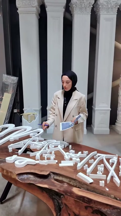 Özel tasarımlı beyaz harfler atölye ortamında ayrıntılarıyla tanıtılıyor.