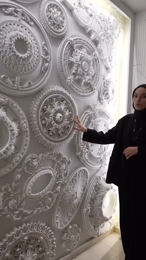 Sunucu, yaprak katmanları bulunan yuvarlak poliüretan dekoru eliyle gösteriyor