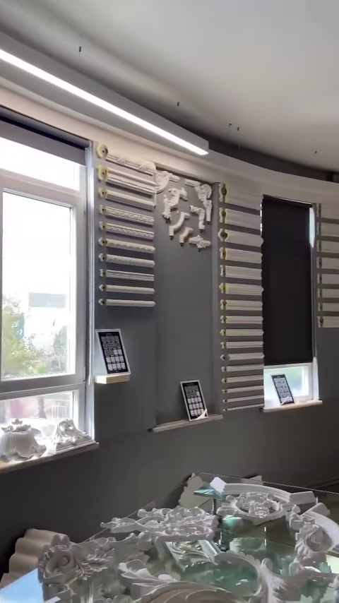 Showroom pencereleri arasında uzun çıta örnekleri ve bezemeler sergileniyor.