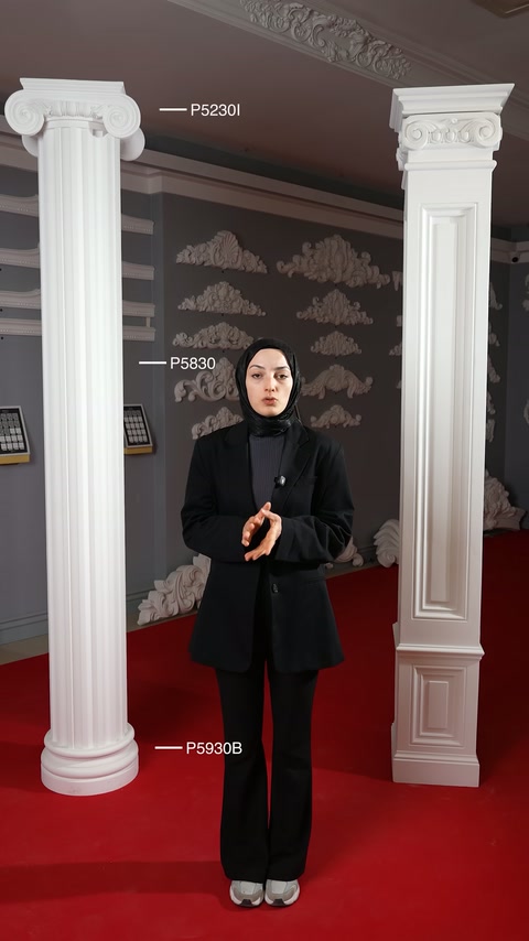 Showroomda sunucu, yuvarlak yivli ve kare gövdeli sütunları tanıtıyor.