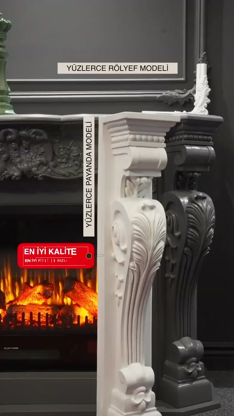 Beyaz payanda önde, siyah model arkada şömine yanında sergileniyor.